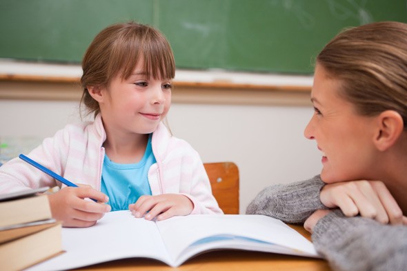 child writing teacher